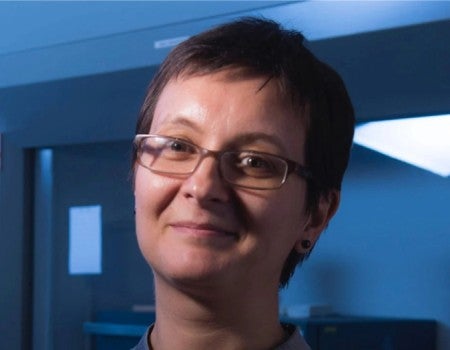 A white woman smiles at the camera