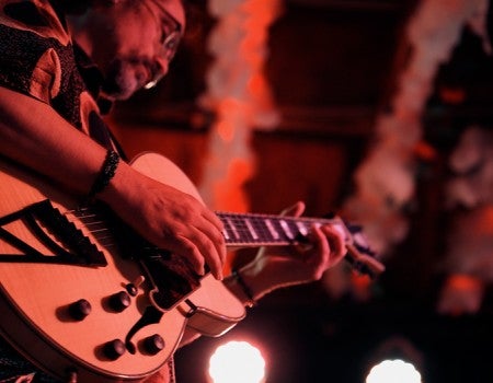 Aurum Son playing guitar