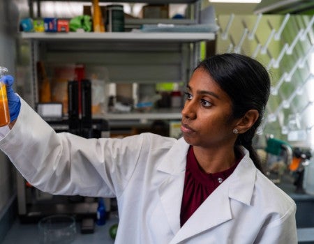 Neethu Pottackal examines a sample of NIVERA’s food coating 
