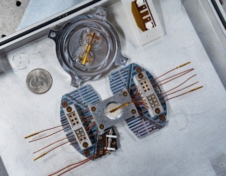 A trapped ion simulator on a metal tray