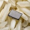 A sample of Rice University's "magnetoelectric" film atop a bed of uncooked rice. Rice neuroengineers created the bi-layered film to power implantable neural stimulators that are approximately the size of a grain of rice. The film converts energy from a magnetic field directly into an electrical voltage, eliminating the need for a battery or wired power connection. (Photo by Jeff Fitlow/Rice University)