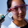 Rice University graduate student Natsumi Komatsu holding a piece of filter membrane paper on which a carbon nanotube film has formed.
