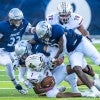 Rice football players tackle a TSU player to the ground