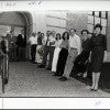 The faculty of Rice University’s Department of English, in a photograph used in the 1987 Campanile Yearbook. They are shown at one of the ramped entrances to Rayzor Hall, with faculty standing in front of the arched doorway or leaning or sitting on the guard rail along the ramp. From left to right: William Piper, Alan Grob, Terrence Doody, John Meixner, Edward Snow, Edward Doughtie, Wesley Morris, Walter Isle, Meredith Skura, Susan Wood, Jack Ward, Max Apple, and Mary Tobin.