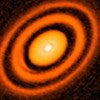 false-color image from the ALMA radio telescope showing a series of rings around young star HD163296 