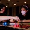 Two students playing board game at Rice Owls After Dark Game Night event