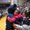 A child hugs Sammy the Owl during School House Mania at Tudor Fieldhouse at Rice University.