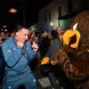 A Rice football player playfully squares up the Southern Miss mascot ahead of the Owls' 2022 LendingTree Bowl appearance in Mobile, Alabama.