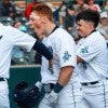 Rice baseball players celebrate during a game with Louisiana.