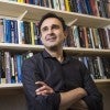 Flavio Cunha in front of his bookcase