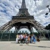 Rice sport management students posing underneath the Eiffel Tower in Paris.