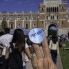 Rice "I voted" sticker with Lovett Hall in the background. 