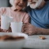 Elderly spouses having coffee