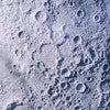 a close up of the moon's surface, which has many craters in it. 