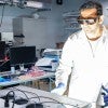 researcher in lab coat wearing gloves and protective glasses opens a device in a lab