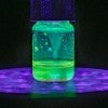 a jar with a glowing green liquid inside