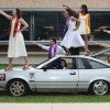 students posing with car