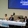 panelists seated at confrence table 