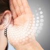 stock photo depicting person holding their hand to their ear 