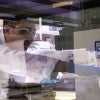 researcher interacting with lab equipment 