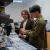 Two researchers working at the lab bench and talking. 