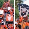 aeiral shots of thousands of Duth soccer fans around the double-decker bus; fans holding a Sammy the Owl cutout in the crowd 