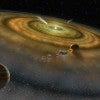 bird's eye view of the developing solar system, with dust in circles around the sun.