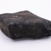 A black rock against a white background 