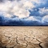 A cracked, dry ground under a cloudy sky.  