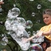 Boy hunting bubbles at the Moody Center for the Arts' Summer Jam 2026 