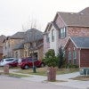 Suburban street with rows of brick homes.  