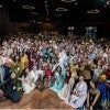 A large group of people dressed in various culture's traditional outfits 