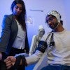 Keya Ghonasgi and Snehil Mathur, a graduate student in Mechanical Engineering, demonstrating how the exoskeleton functions  