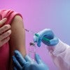 Vaccination in healthcare setting with injection.  