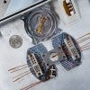 A trapped ion simulator on a metal tray 