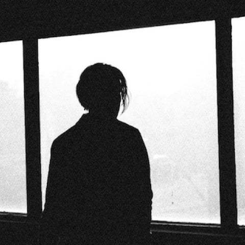Photo of teen looking out the window.